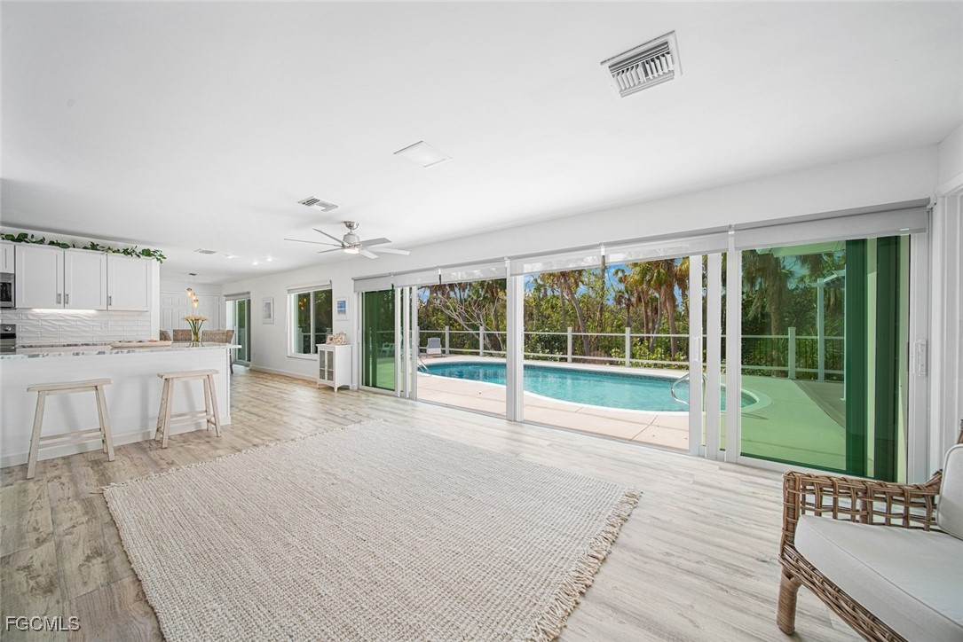 4639 Brainard Bayou Road Sanibel, FL 33957 - Photo 19 of 50 a view of a patio with table and chairs near a large window