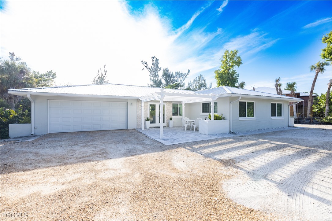4639 Brainard Bayou Road Sanibel, FL 33957 - Photo 2 of 50 a front view of a house with a yard
