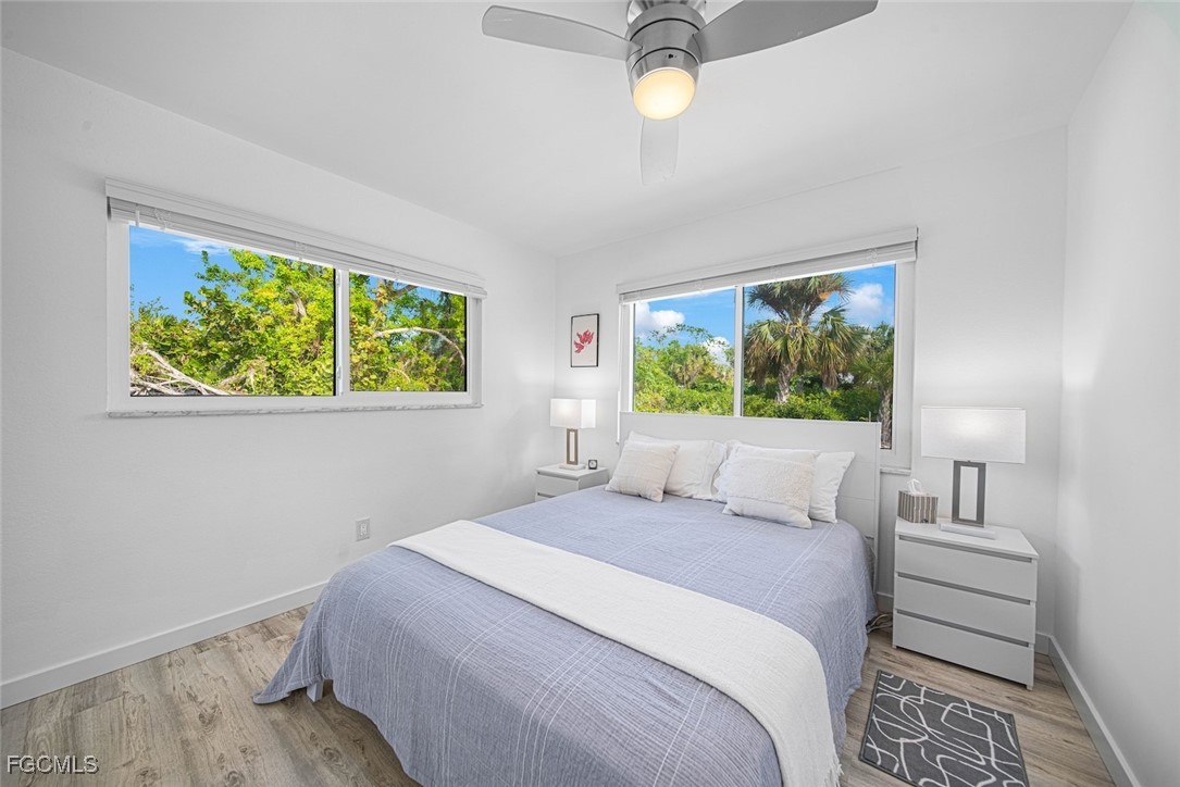 4639 Brainard Bayou Road Sanibel, FL 33957 - Photo 31 of 50 a bedroom with a bed and a window