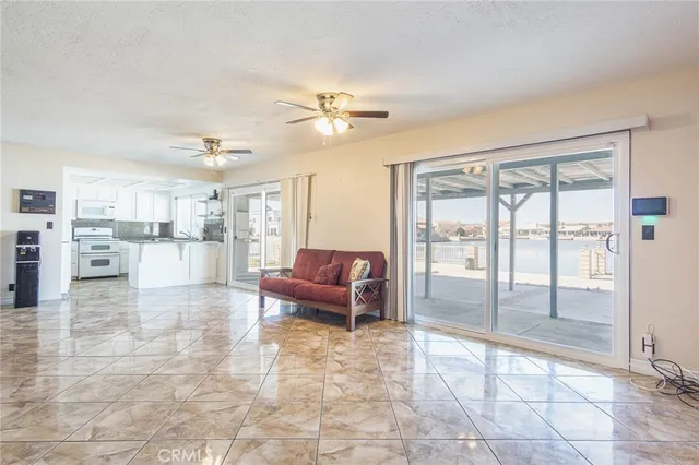 a living room with furniture and a ceiling fan