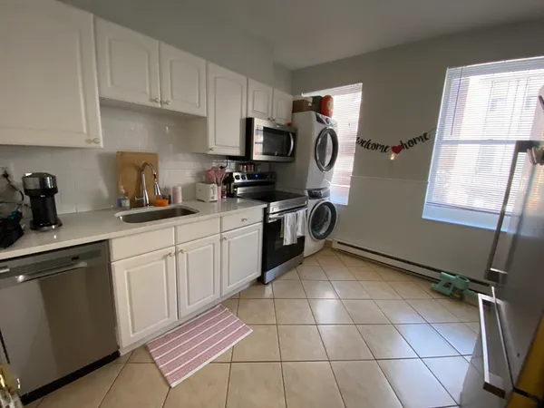 a kitchen with a sink a stove and cabinets