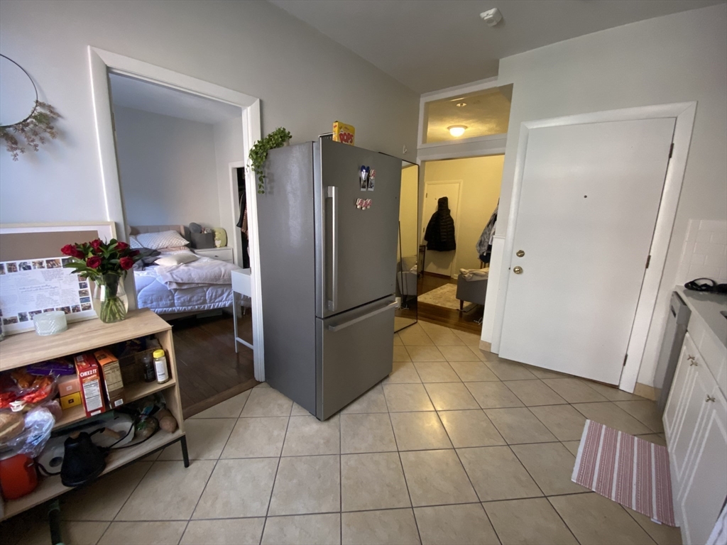 5 Battery Street, Unit 2F Boston, MA 02109 - Photo 13 of 15 a kitchen with stainless steel appliances granite countertop a refrigerator and a sink