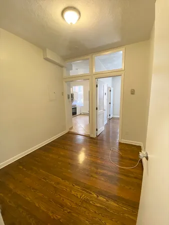 a view of a room with wooden floor