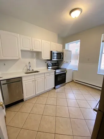 a kitchen with a sink a stove a microwave and cabinets