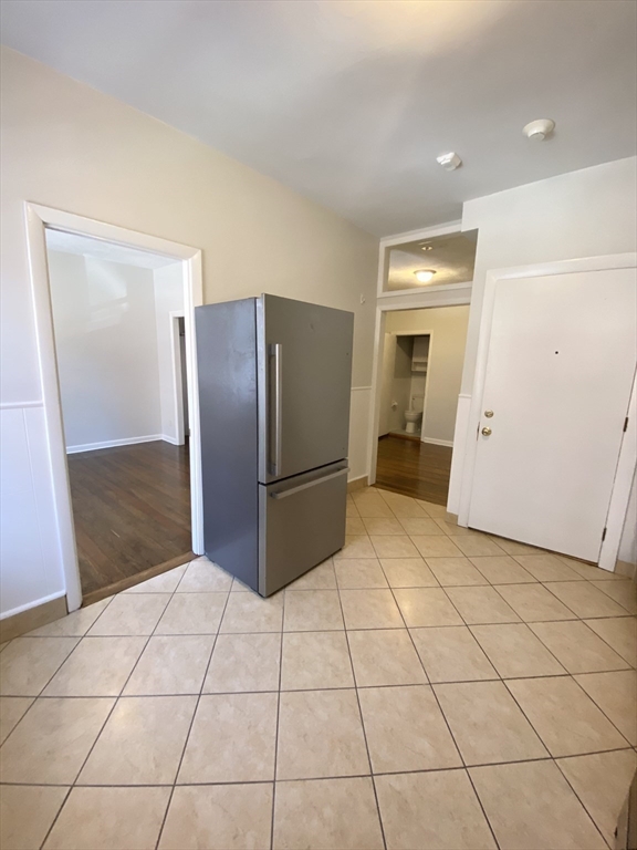 5 Battery Street, Unit 2F Boston, MA 02109 - Photo 6 of 15 a kitchen with stainless steel appliances a refrigerator and a counter top space