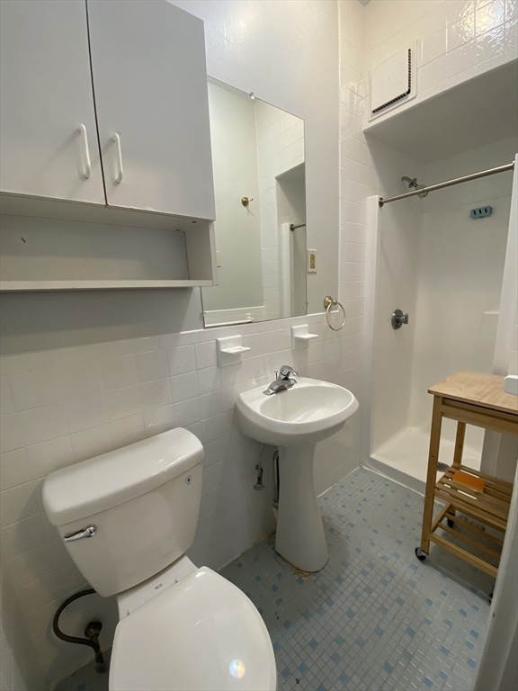 5 Battery Street, Unit 2F Boston, MA 02109 - Photo 7 of 15 a bathroom with a sink toilet and shower