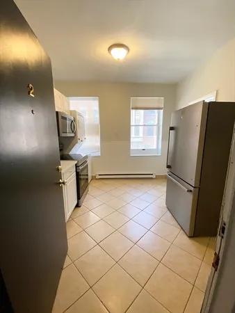 a view of a refrigerator in kitchen and livingroom