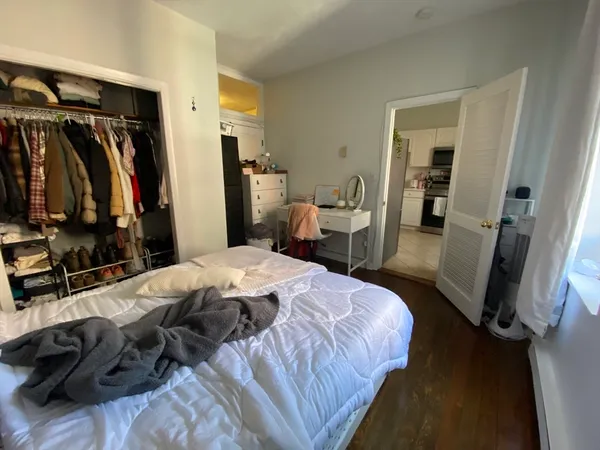 a bedroom with a bed and a mirror