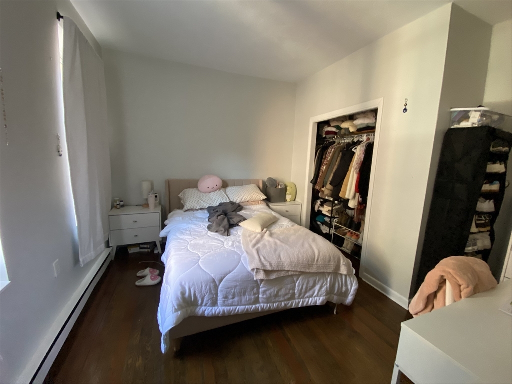 5 Battery Street, Unit 2F Boston, MA 02109 - Photo 10 of 15 a bedroom with a bed wooden floor and a table