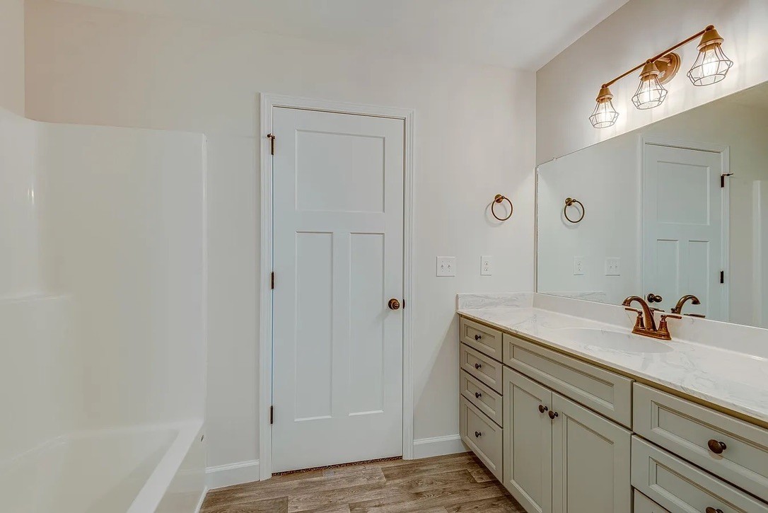 746 Nels Adams Road Dickson, TN 37055 - Photo 32 of 63 a bathroom with a sink a mirror and shower