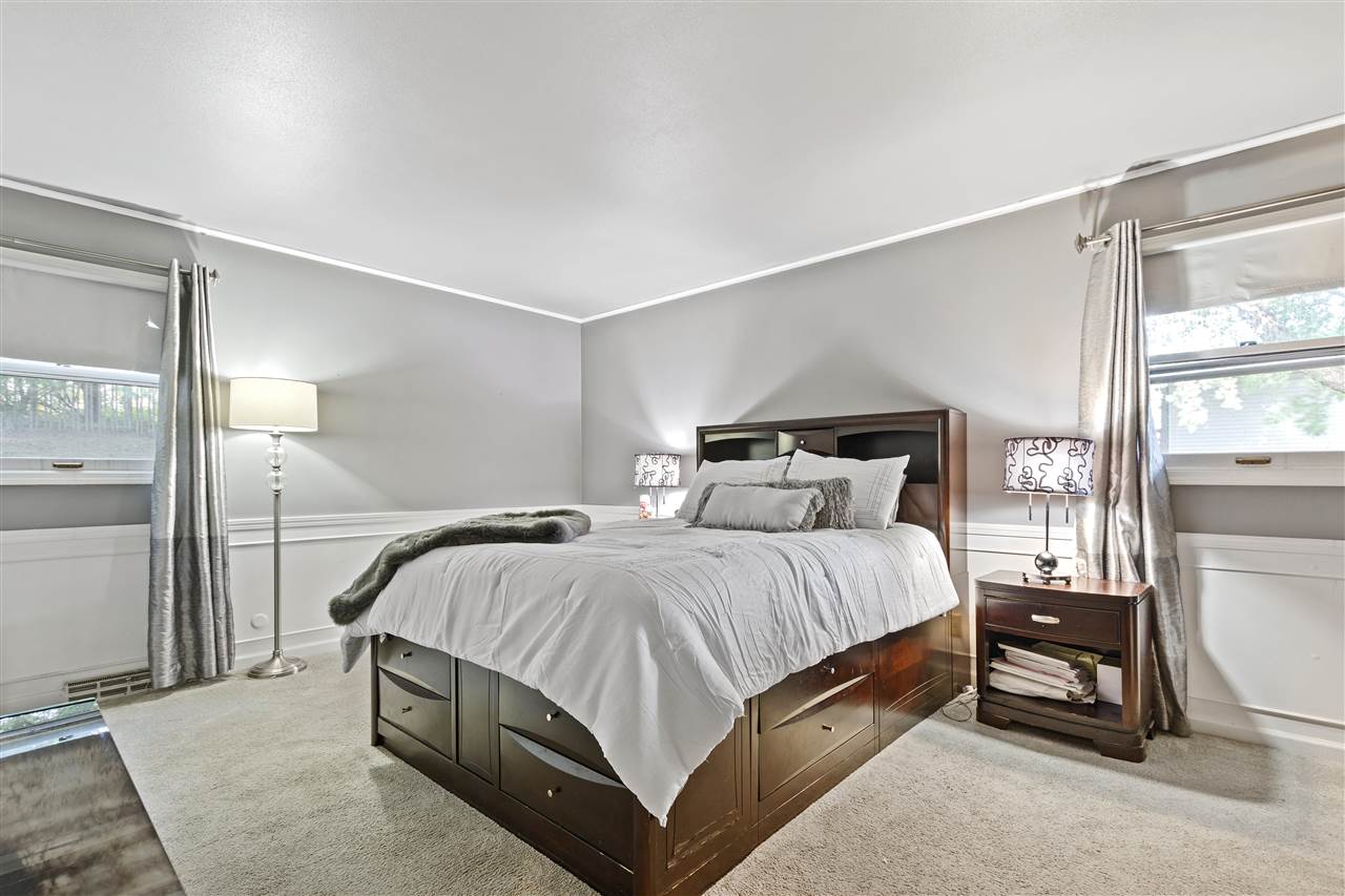 4570 Sunderman Road Rockford, IL 61114 - Photo 11 of 17 a bedroom with a bed a mirror and a window