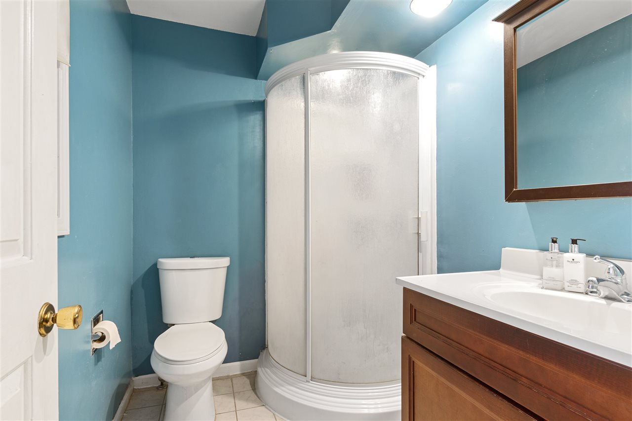 4570 Sunderman Road Rockford, IL 61114 - Photo 12 of 17 a bathroom with a toilet sink vanity and mirror