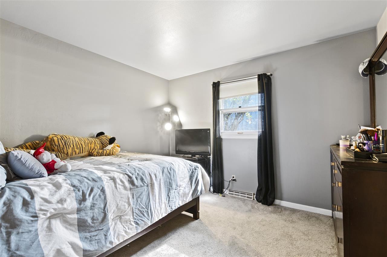 4570 Sunderman Road Rockford, IL 61114 - Photo 13 of 17 a bedroom with a bed and wooden floor