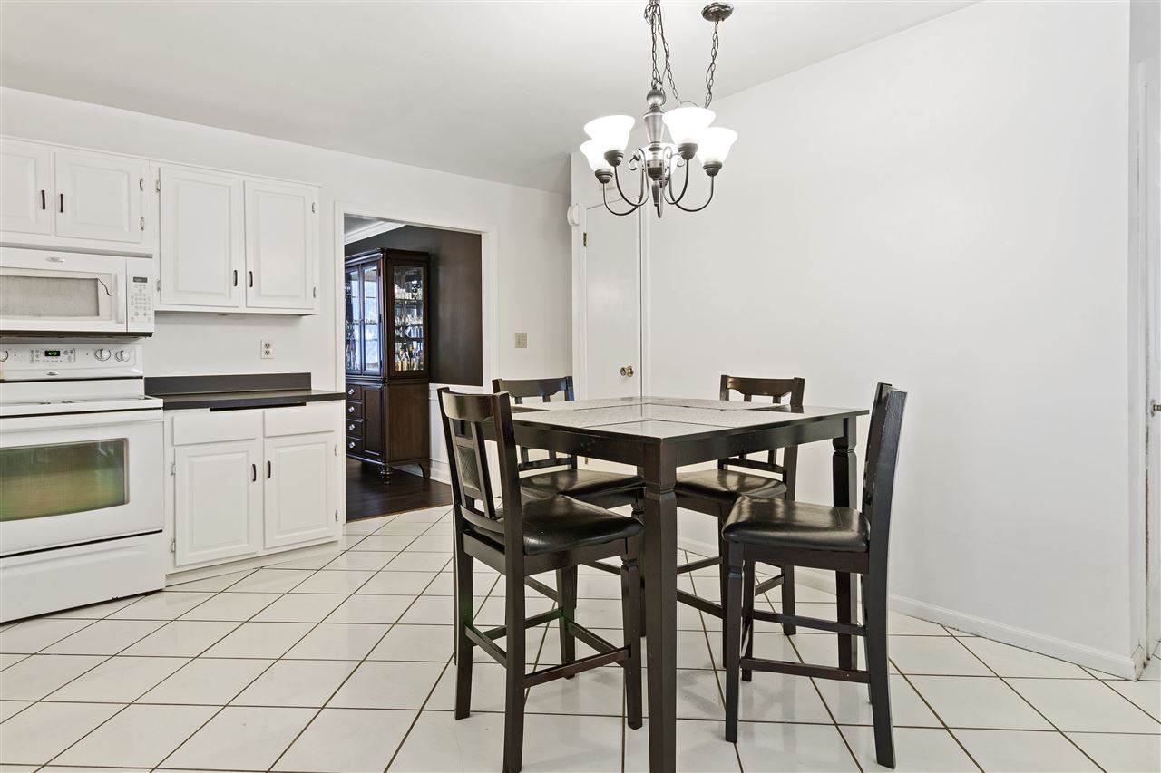 4570 Sunderman Road Rockford, IL 61114 - Photo 8 of 17 a view of a dining room with furniture and chandelier