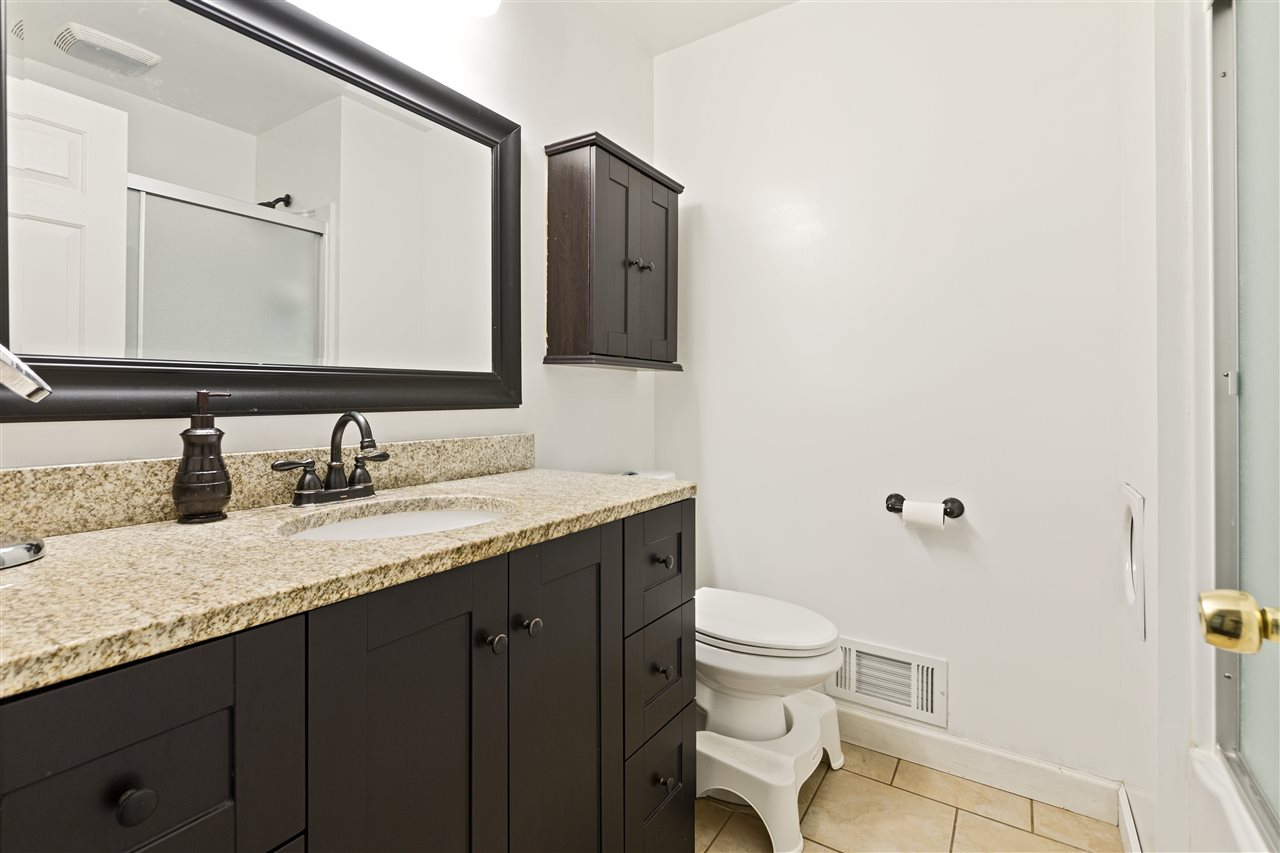 4570 Sunderman Road Rockford, IL 61114 - Photo 10 of 17 a bathroom with a granite countertop sink and a mirror