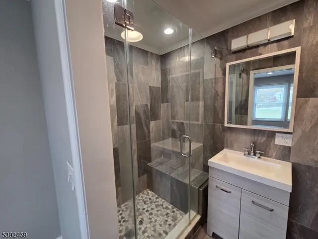 a bathroom with a sink a light fixture and a mirror