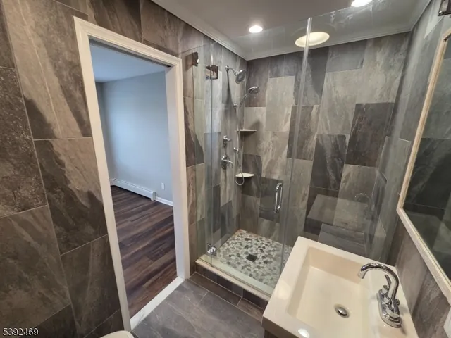 a bathroom with a shower and a sink