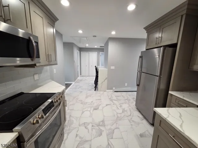 a kitchen with stainless steel appliances a refrigerator and a sink
