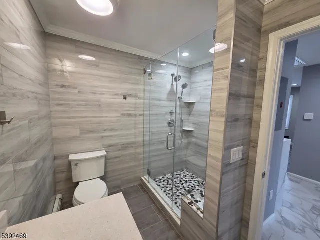 a bathroom with a toilet and shower