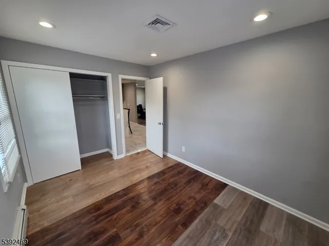 a view of hallway with wooden floor