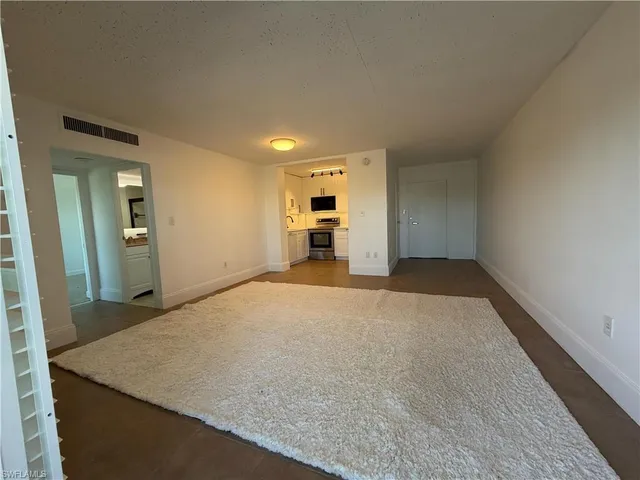 an empty room with kitchen and sink