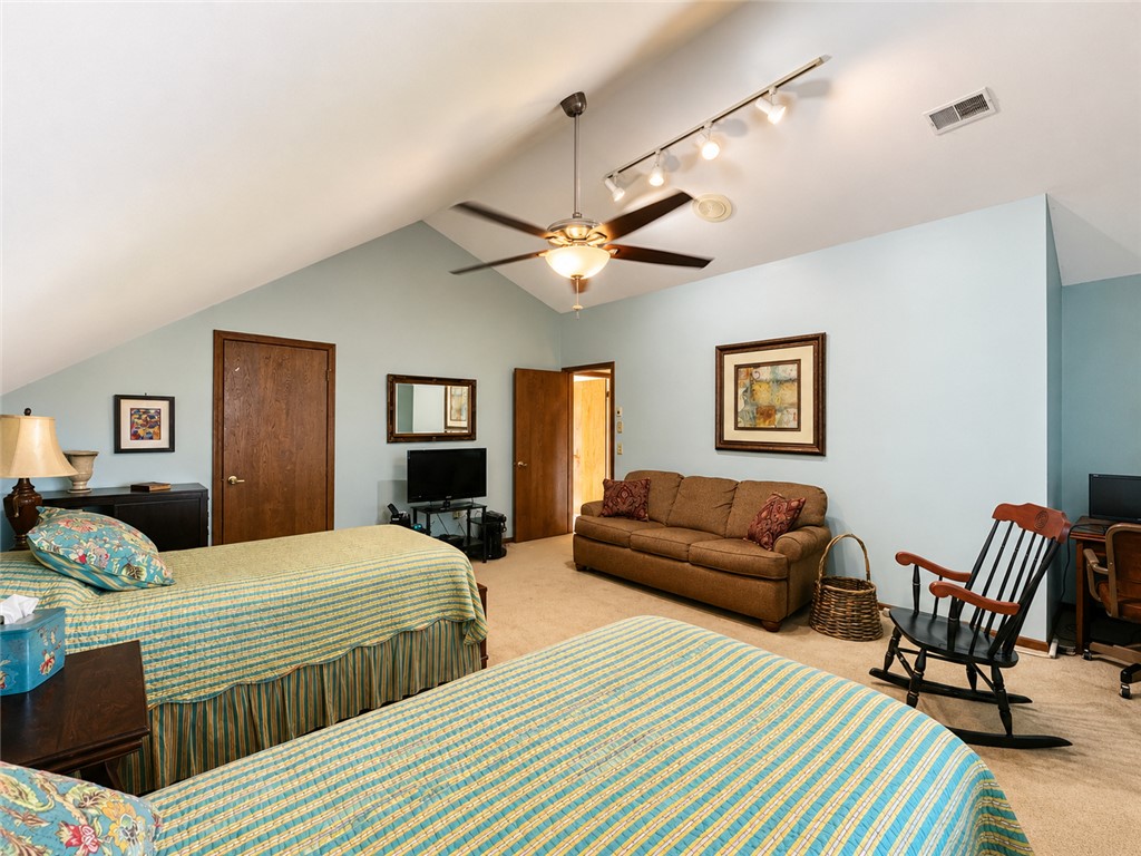 222 Terrace Drive Anderson, SC 29621 - Photo 19 of 37 A spacious bedroom with a vaulted ceiling and an inviting seating area.