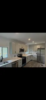a kitchen with stainless steel appliances a sink stove and cabinets