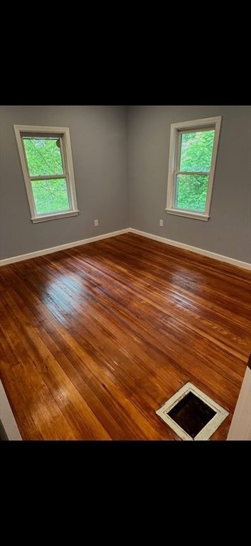 19 Dell Avenue, Unit 2 Boston, MA 02136 - Photo 4 of 6 a view of an empty room with wooden floor and a window