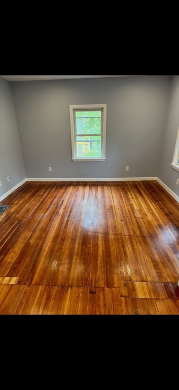 19 Dell Avenue, Unit 2 Boston, MA 02136 - Photo 5 of 6 a view of an empty room with wooden floor and a window