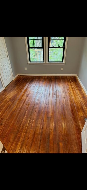 19 Dell Avenue, Unit 2 Boston, MA 02136 - Photo 6 of 6 a view of empty room with wooden floor and fan