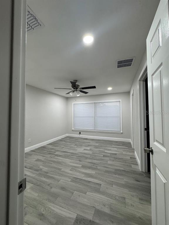 12142 Caper Street Orlando, FL 32837 - Photo 11 of 15 a view of empty room with wooden floor