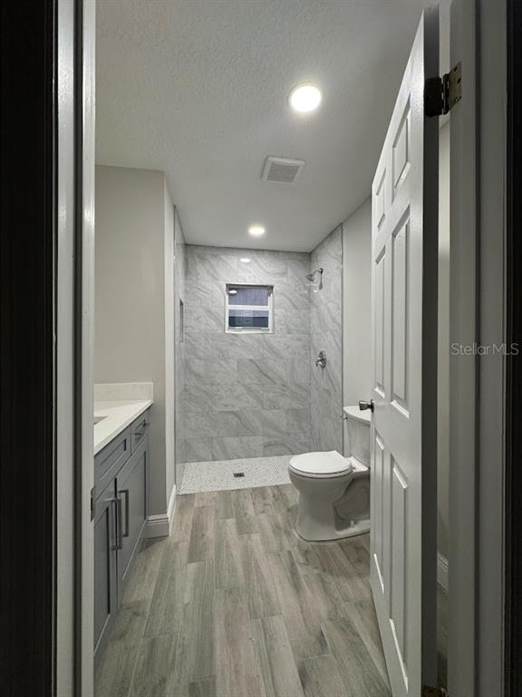 12142 Caper Street Orlando, FL 32837 - Photo 12 of 15 a bathroom with a bathtub shower sink mirror and toilet