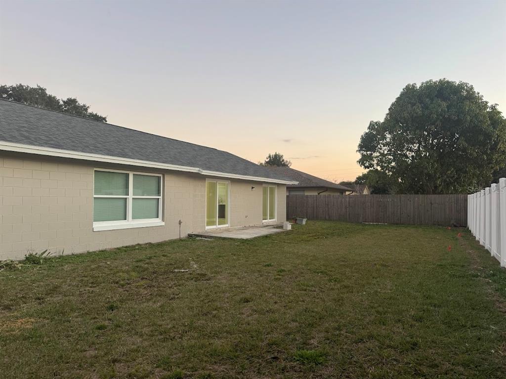 12142 Caper Street Orlando, FL 32837 - Photo 14 of 15 a backyard of a house
