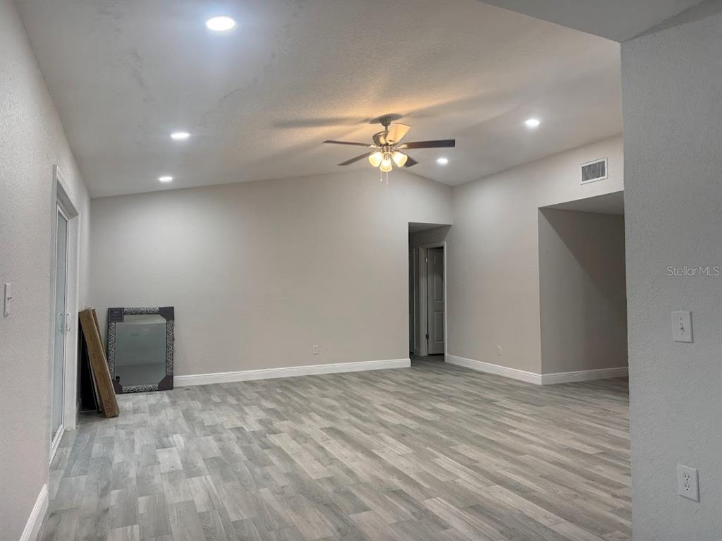 12142 Caper Street Orlando, FL 32837 - Photo 4 of 15 a view of an empty room with a ceiling fan