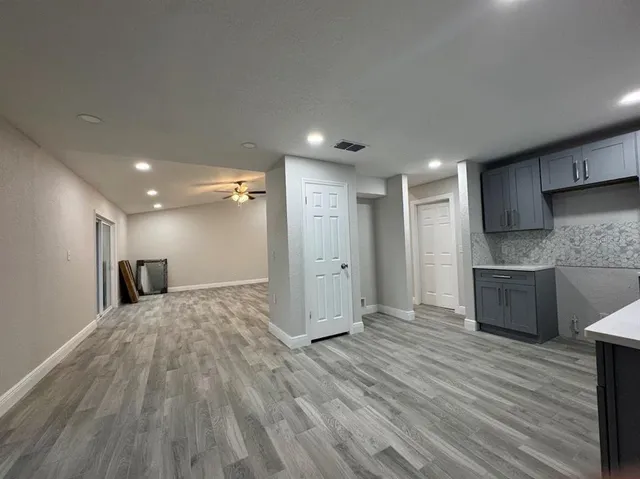 a view of a kitchen with a sink and a refrigerator