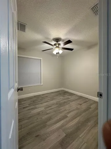 a view of a room with wooden floor