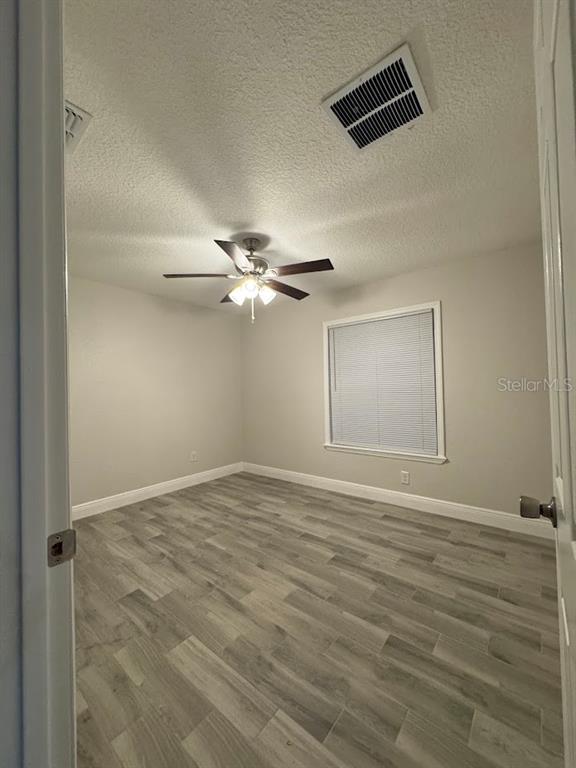 12142 Caper Street Orlando, FL 32837 - Photo 9 of 15 a view of an empty room with a ceiling fan