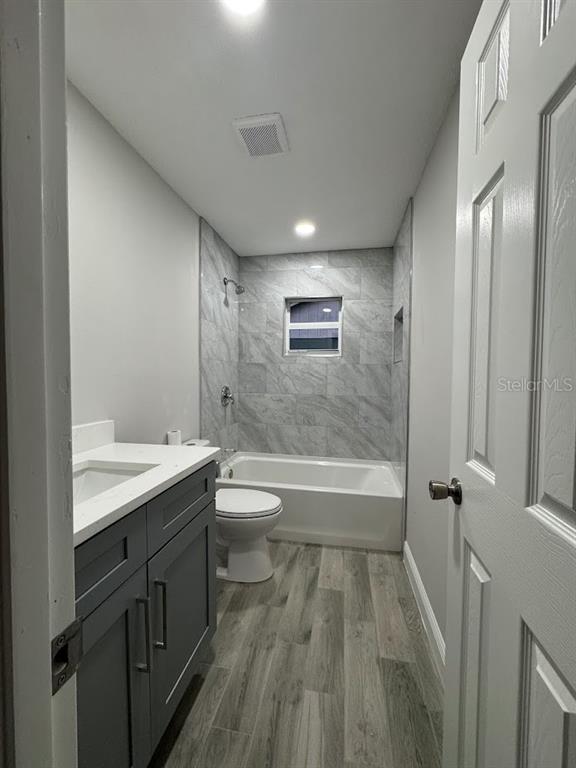 12142 Caper Street Orlando, FL 32837 - Photo 10 of 15 a bathroom with a granite countertop sink toilet and shower