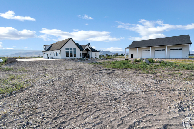 1952 Highway 118 Monroe, UT 84754 - Photo 72 of 88 View of front facade with a detached garage, a mountain view, and driveway