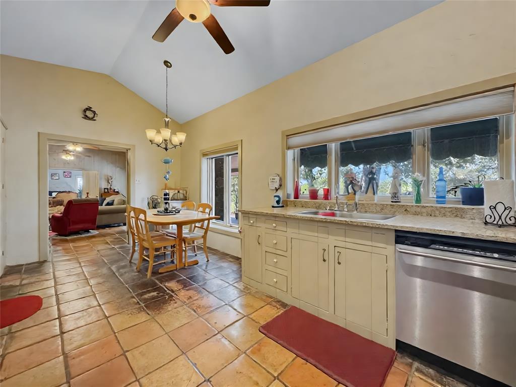 5167 Rockhill Road Aubrey, TX 76227 - Photo 14 of 29 a kitchen with stainless steel appliances kitchen island granite countertop dining room cabinets and living room view