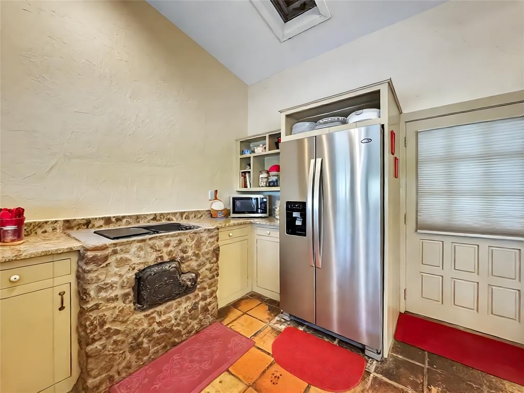 5167 Rockhill Road Aubrey, TX 76227 - Photo 16 of 29 a kitchen with a refrigerator and a stove top oven