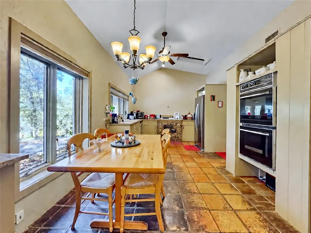 5167 Rockhill Road Aubrey, TX 76227 - Photo 17 of 29 a view of a dining room with furniture wooden floor and chandelier