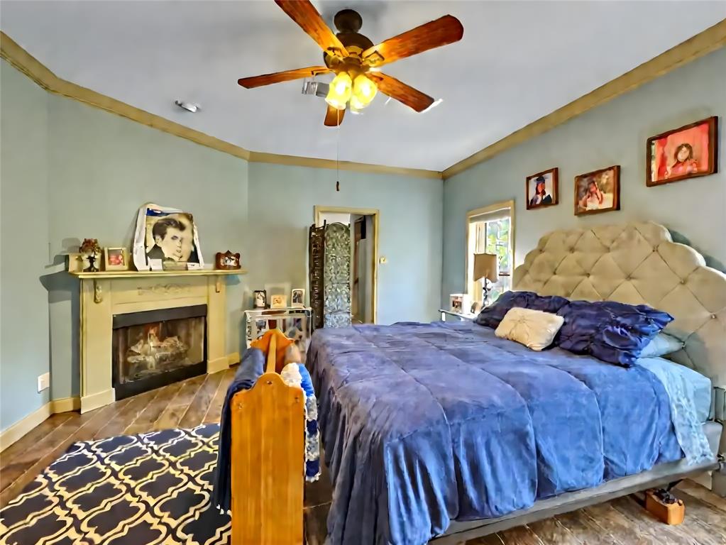 5167 Rockhill Road Aubrey, TX 76227 - Photo 19 of 29 a bedroom with a bed and a fireplace