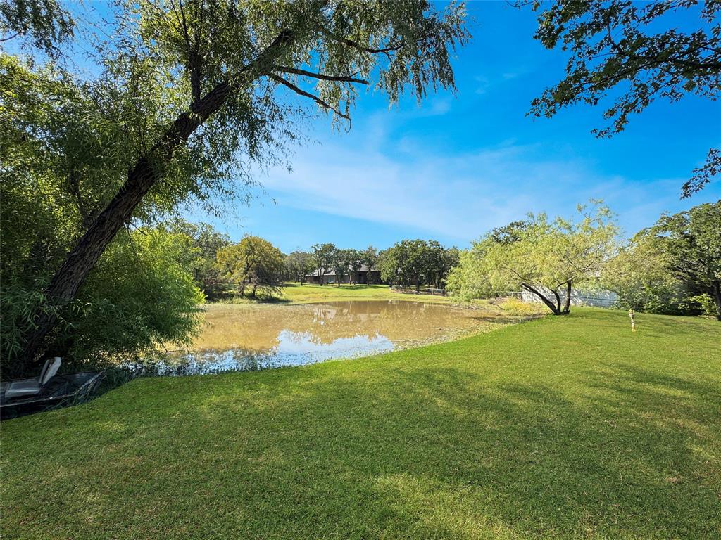 5167 Rockhill Road Aubrey, TX 76227 - Photo 23 of 29 a view of a lake from a yard