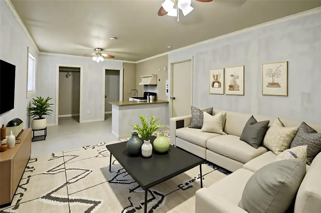 5167 Rockhill Road Aubrey, TX 76227 - Photo 10 of 29 a living room with furniture a chandelier and a flat screen tv