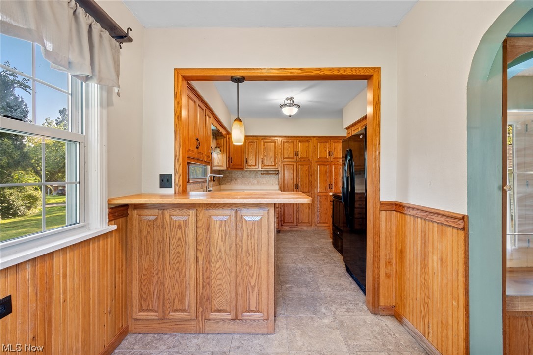3948 Cox Road Barberton, OH 44203 - Photo 12 of 32 Kitchen with pendant lighting, light tile flooring, oak cabinets, light countertops, and backsplash