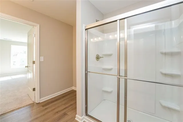 a bathroom with a glass shower door