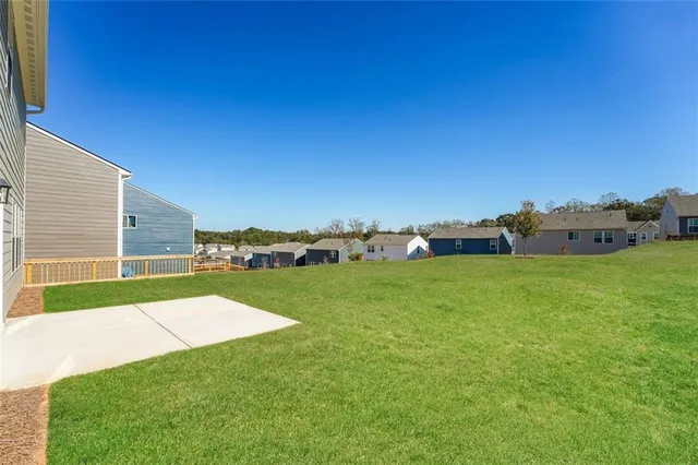 a view of a field of grass and trees