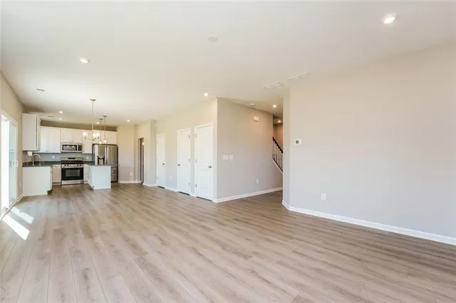 a view of a kitchen with a sink and a refrigerator