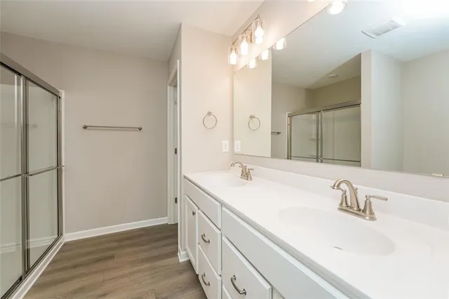 a bathroom with a sink double vanity and a mirror